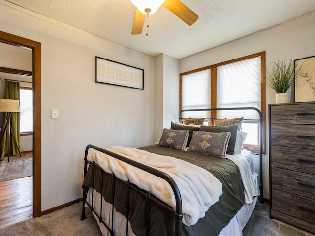 carpeted bedroom featuring baseboards and ceiling fan