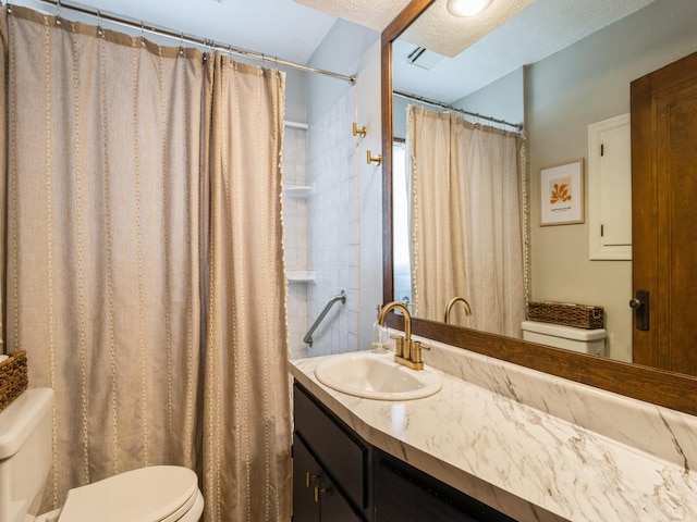 bathroom with toilet, a textured ceiling, a shower with curtain, and vanity