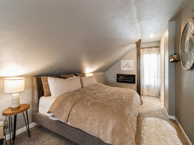bedroom with a textured ceiling, vaulted ceiling, baseboards, and carpet