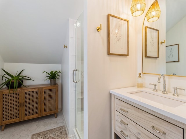 bathroom with vanity, lofted ceiling, and a stall shower