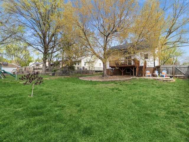 view of yard featuring a fenced backyard, stairway, and a deck