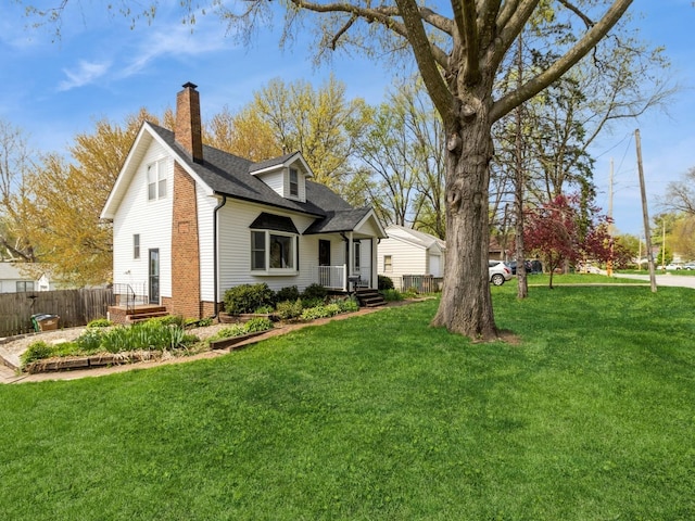 view of home's exterior featuring a lawn, a shingled roof, fence, and a chimney
