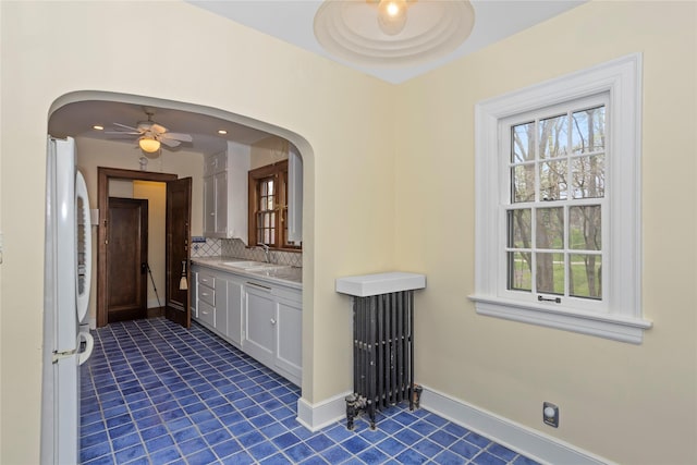 5502 Ingersoll Ave, Des Moines, IA 50312 - bathroom featuring backsplash, a ceiling fan, tile patterned floors, vanity, and radiator heating unit