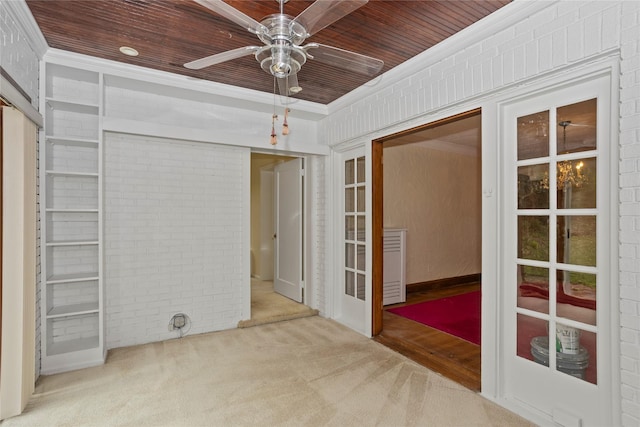 5502 Ingersoll Ave, Des Moines, IA 50312 - interior space with wood ceiling, ceiling fan, carpet flooring, and brick wall