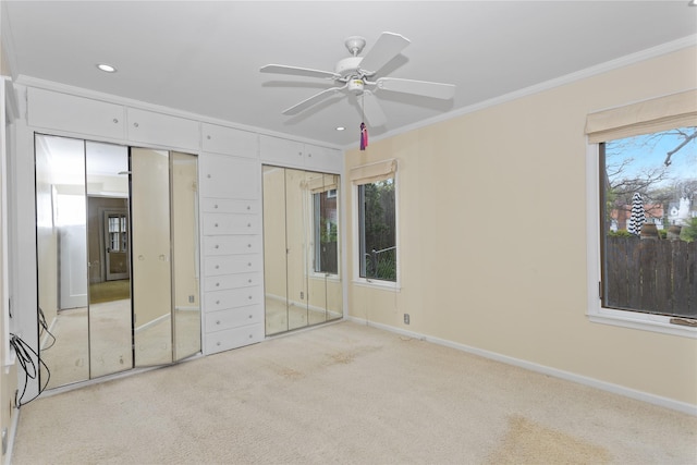 5502 Ingersoll Ave, Des Moines, IA 50312 - unfurnished bedroom featuring crown molding, light colored carpet, two closets, recessed lighting, and baseboards