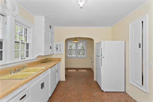 5502 Ingersoll Ave, Des Moines, IA 50312 - kitchen with a sink, plenty of natural light, white appliances, and white cabinetry