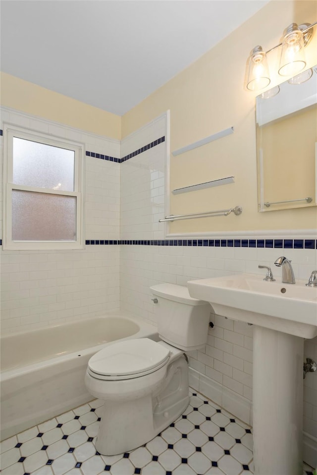 5502 Ingersoll Ave, Des Moines, IA 50312 - full bath with a sink, a wainscoted wall, toilet, and tile walls