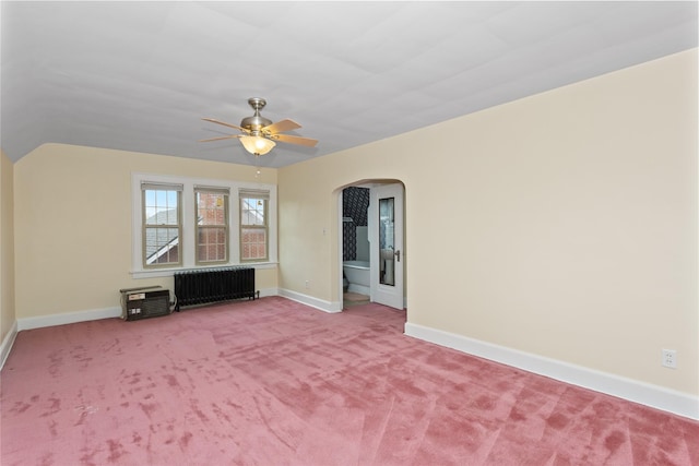 5502 Ingersoll Ave, Des Moines, IA 50312 - interior space with baseboards, arched walkways, ceiling fan, and radiator heating unit
