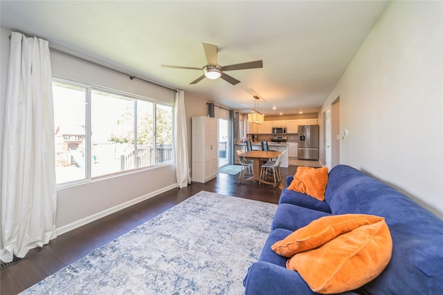 1009 SE 5th St, Grimes, IA 50111 - living room with a ceiling fan, dark wood finished floors, and baseboards