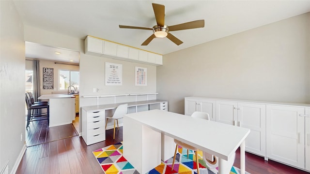 1009 SE 5th St, Grimes, IA 50111 - bedroom with dark wood-type flooring, an office area, a sink, and ceiling fan