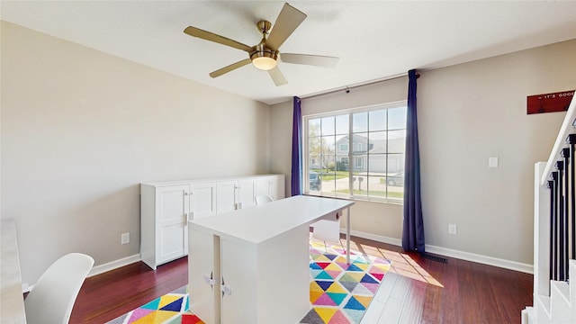 1009 SE 5th St, Grimes, IA 50111 - bedroom with dark wood-style floors, baseboards, and a ceiling fan