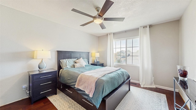 1009 SE 5th St, Grimes, IA 50111 - bedroom with dark wood finished floors, a textured ceiling, a ceiling fan, and baseboards
