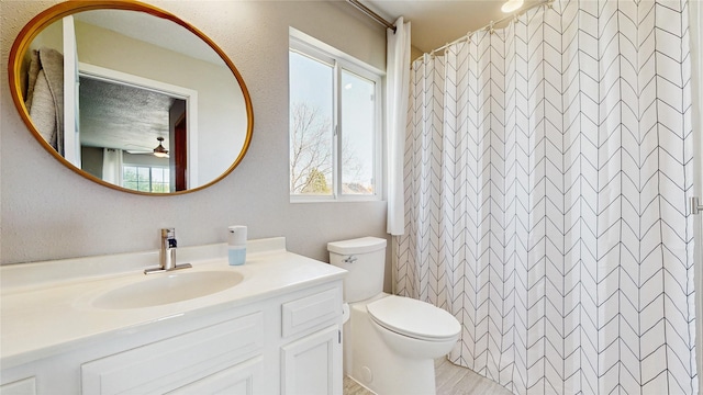 1009 SE 5th St, Grimes, IA 50111 - full bathroom with toilet, vanity, ceiling fan, and a shower with curtain