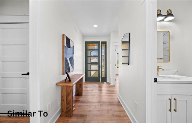 355 NW Red Oak Dr, Waukee, IA 50263 - hall with a sink, baseboards, recessed lighting, and light wood-style flooring