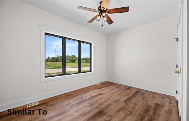 355 NW Red Oak Dr, Waukee, IA 50263 - unfurnished room with baseboards, a ceiling fan, wood finished floors, and visible vents