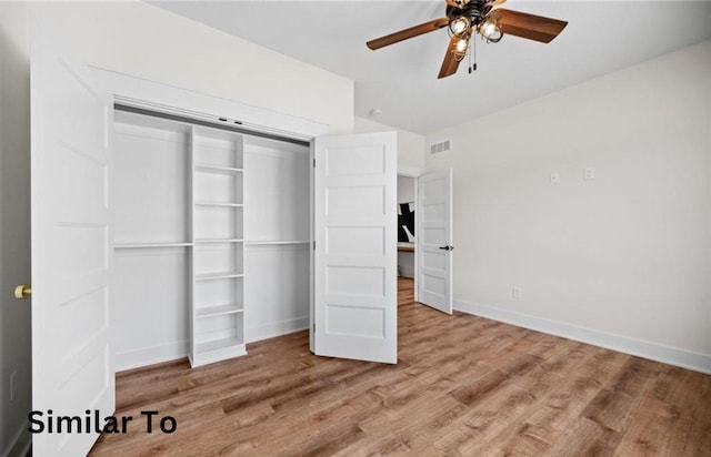 355 NW Red Oak Dr, Waukee, IA 50263 - unfurnished bedroom featuring baseboards, visible vents, wood finished floors, and a closet