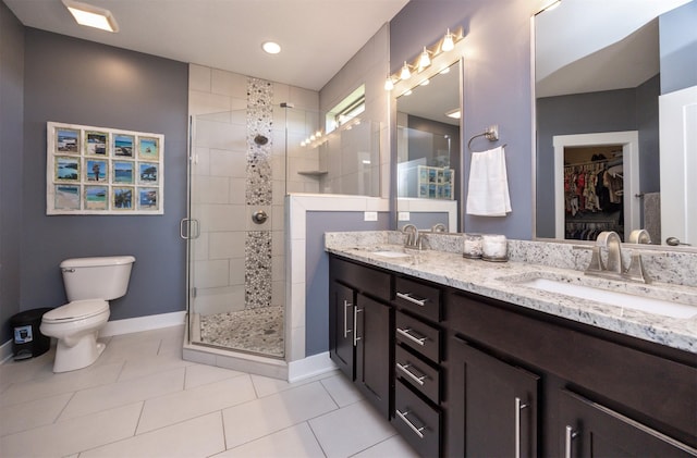 bathroom with baseboards, a sink, tile patterned floors, and a shower stall
