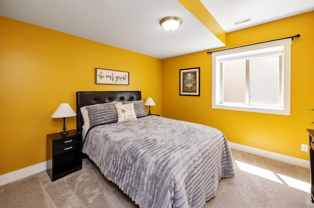 carpeted bedroom with baseboards and visible vents