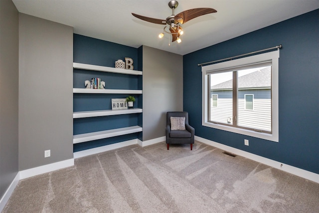unfurnished room featuring baseboards, carpet, a ceiling fan, and visible vents