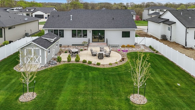 970 Roman Rd, Waukee, IA 50263 - rear view of property with a fenced backyard, a shed, a shingled roof, a patio area, and a residential view