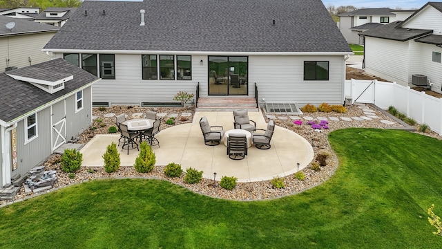 970 Roman Rd, Waukee, IA 50263 - rear view of house with a patio, a shingled roof, a lawn, and a fenced backyard
