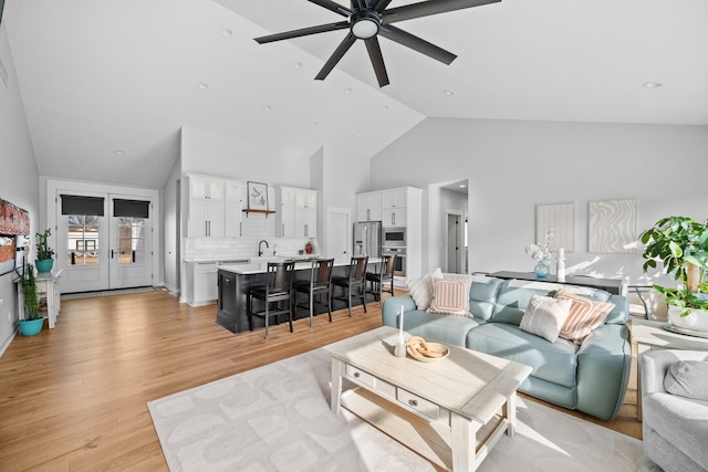 970 Roman Rd, Waukee, IA 50263 - living room with high vaulted ceiling, a ceiling fan, and light wood finished floors