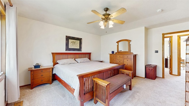 bedroom with baseboards, ceiling fan, and light colored carpet