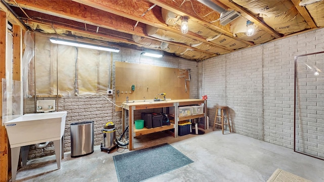 unfinished basement featuring a workshop area