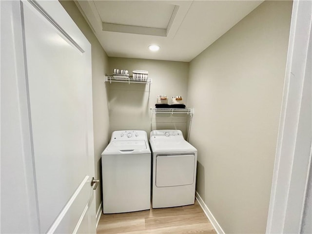 clothes washing area with laundry area, attic access, recessed lighting, washing machine and clothes dryer, and light wood-style flooring