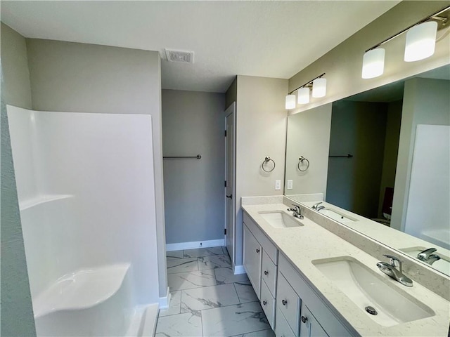 bathroom with a sink, visible vents, double vanity, and marble finish floor
