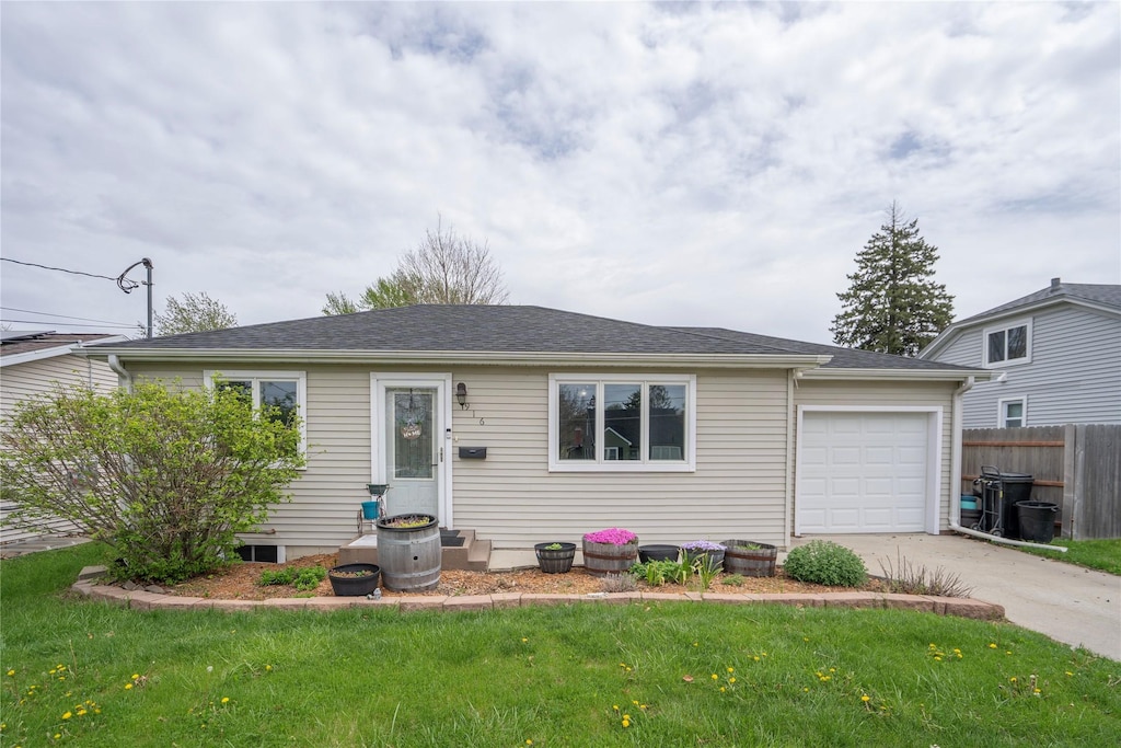 single story home with concrete driveway, fence, a front yard, and a garage