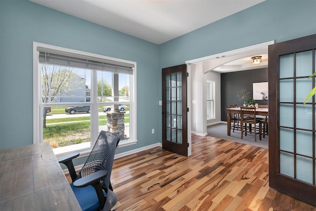 7517 NW 97th Ct, Johnston, IA 50131 - office space featuring wood finished floors, french doors, and arched walkways