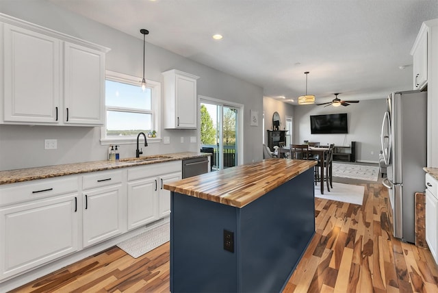 7517 NW 97th Ct, Johnston, IA 50131 - kitchen with appliances with stainless steel finishes, wood counters, ceiling fan, light wood-style floors, and recessed lighting