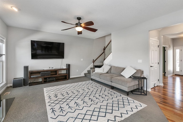 7517 NW 97th Ct, Johnston, IA 50131 - living room with ceiling fan, baseboards, stairway, and wood finished floors