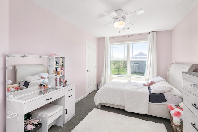 7517 NW 97th Ct, Johnston, IA 50131 - bedroom with dark colored carpet, ceiling fan, and baseboards