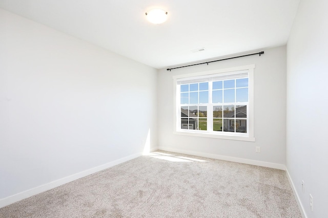 unfurnished room with baseboards and carpet flooring