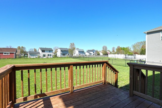 deck with a lawn, a residential view, and a fenced backyard