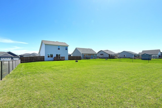 view of yard with a fenced backyard and a residential view