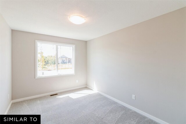 2912 6th Ave SW, Altoona, IA 50009 - empty room with baseboards, carpet flooring, and visible vents