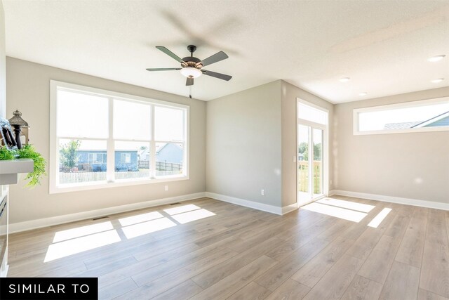 2917 6th Ave SW, Altoona, IA 50009 - empty room featuring baseboards, ceiling fan, light wood-type flooring, and visible vents