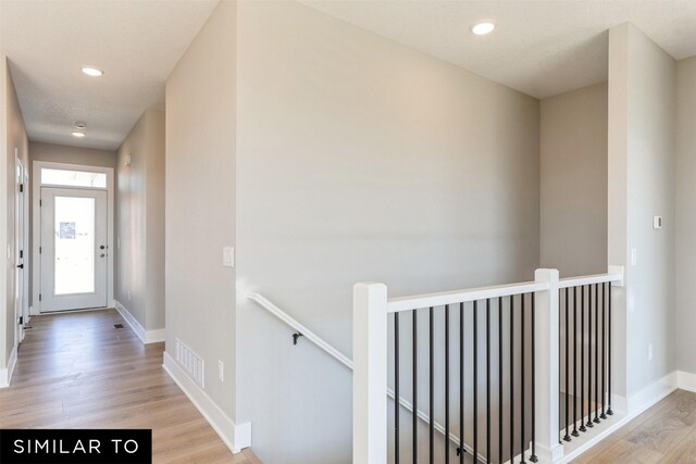 2917 6th Ave SW, Altoona, IA 50009 - hall with recessed lighting, baseboards, an upstairs landing, light wood-type flooring, and visible vents