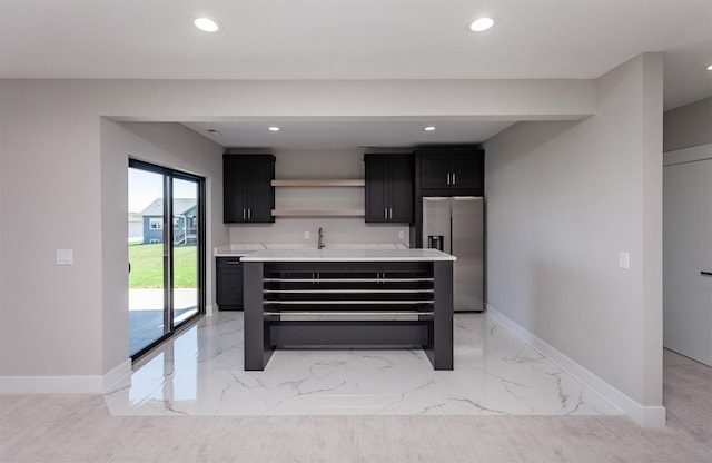 kitchen featuring open shelves, dark cabinetry, marble finish floor, baseboards, and stainless steel refrigerator with ice dispenser