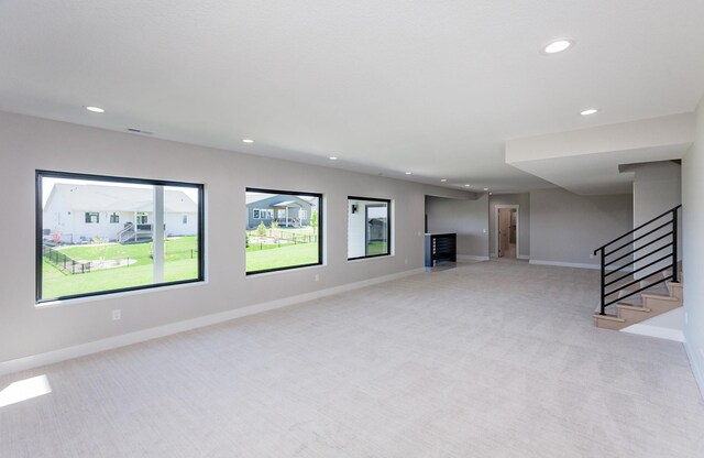 17778 Hammontree Dr, Clive, IA 50325 - unfurnished living room featuring recessed lighting, light colored carpet, baseboards, and stairway
