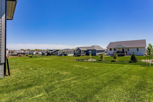 view of yard with a residential view and fence