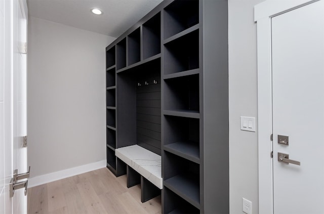 mudroom with recessed lighting, baseboards, and light wood finished floors
