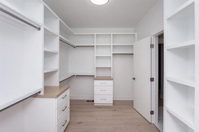 walk in closet featuring light wood finished floors