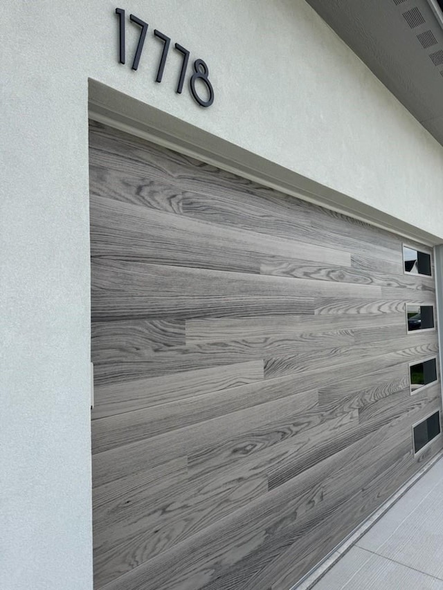 exterior details featuring visible vents and stucco siding