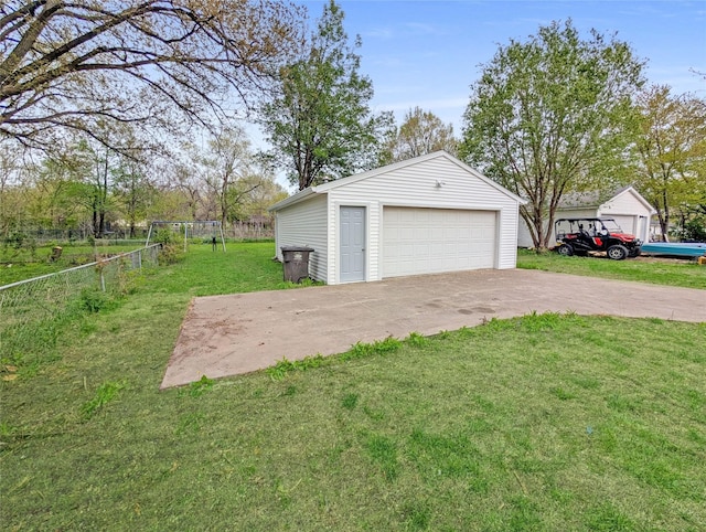 detached garage featuring fence