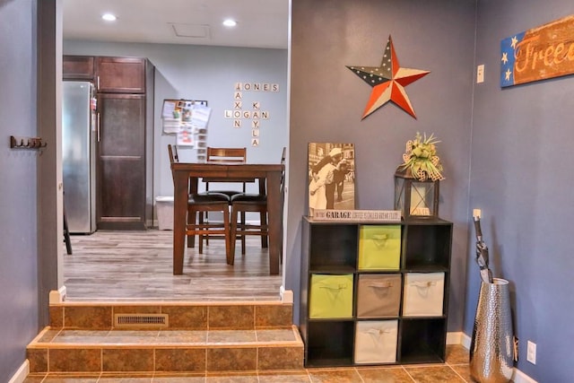 hall featuring recessed lighting, baseboards, and visible vents