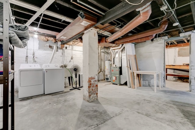 unfinished below grade area with washer and dryer, heating unit, and water heater